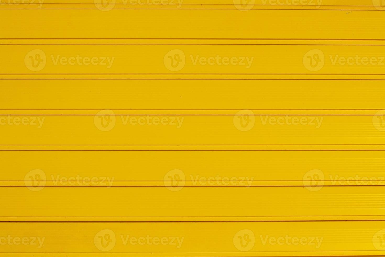 Background texture of horizontal yellow gate panels. Wide and narrow stripes. photo