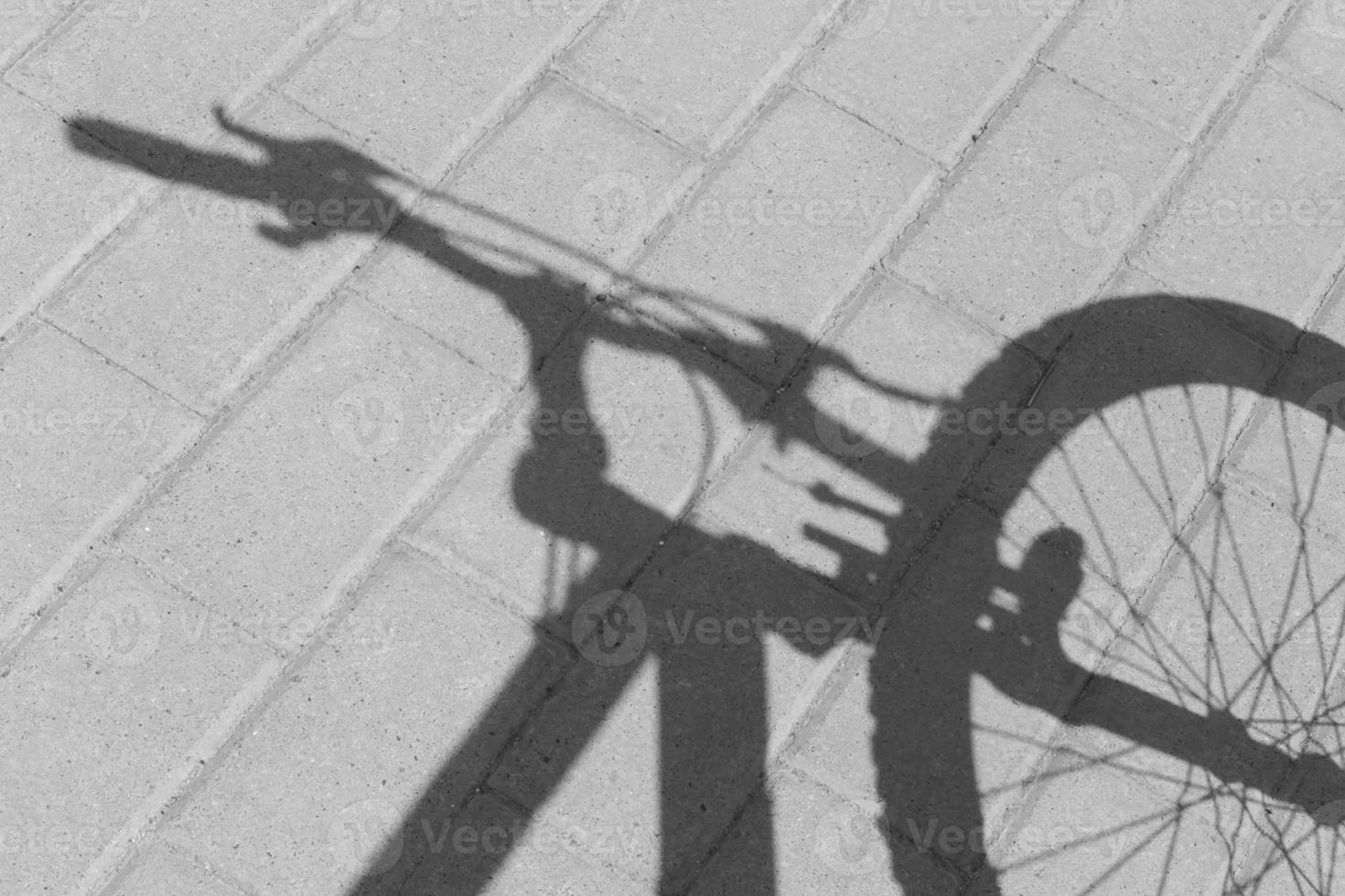 black and white photo of shadow of front part of bicycle