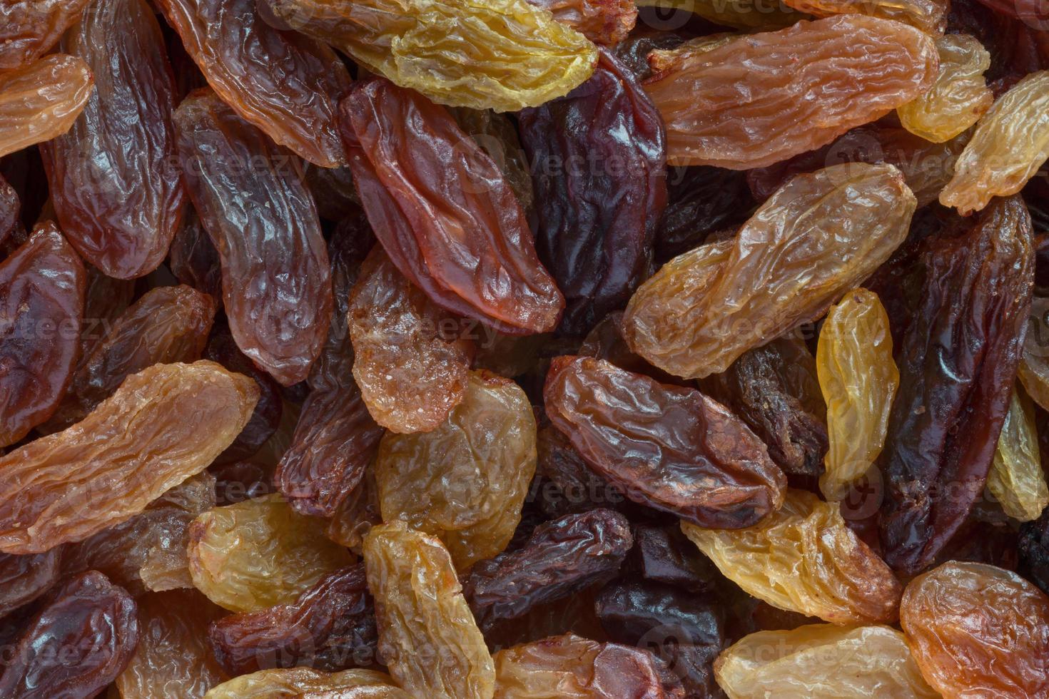 close up of dark brown and golden raisins background photo