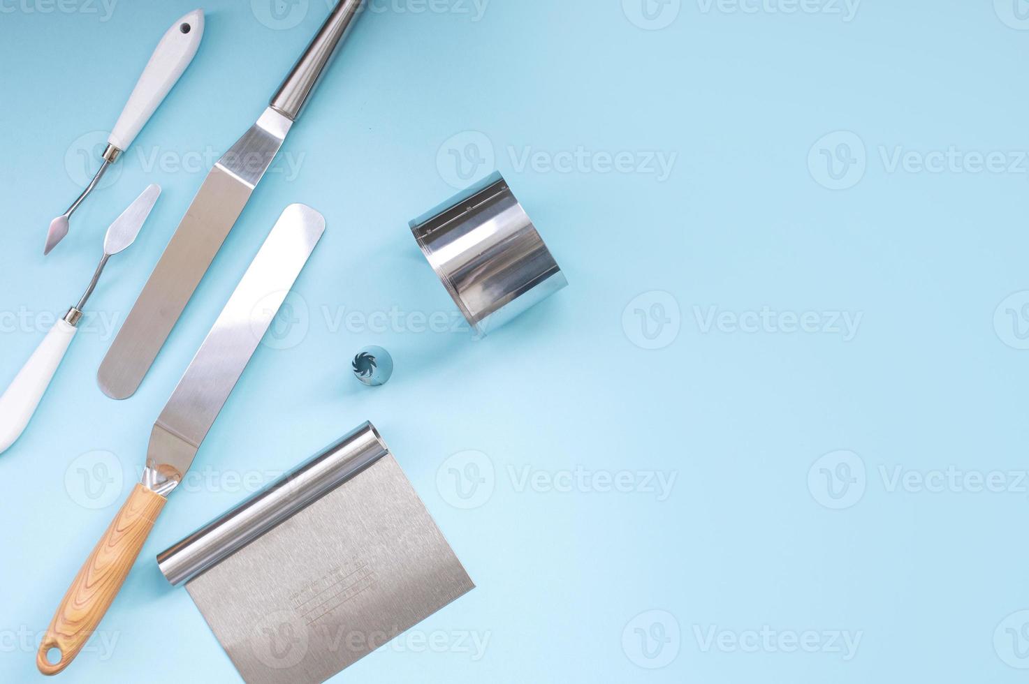 A set of tools for a pastry chef, a spatula for decorating a cake with cream, a ring cake mold photo