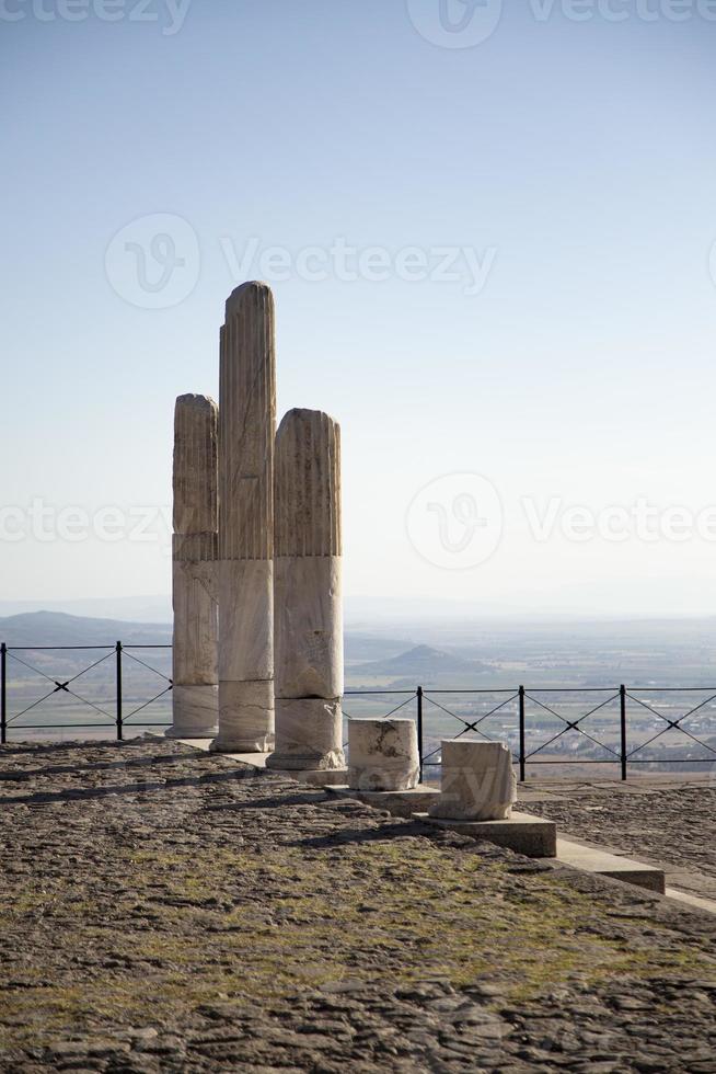 Ancient Ruins of Pergamon Acropolis. Ancient city column ruins with the cityscape in the background. photo
