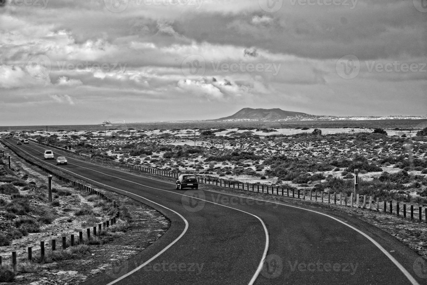 landscape with road and ocean on the spanish canary island of fuertaventra on a sunny day photo