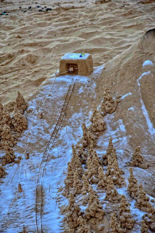 sand sculpture on the beach against the backdrop of the ocean photo