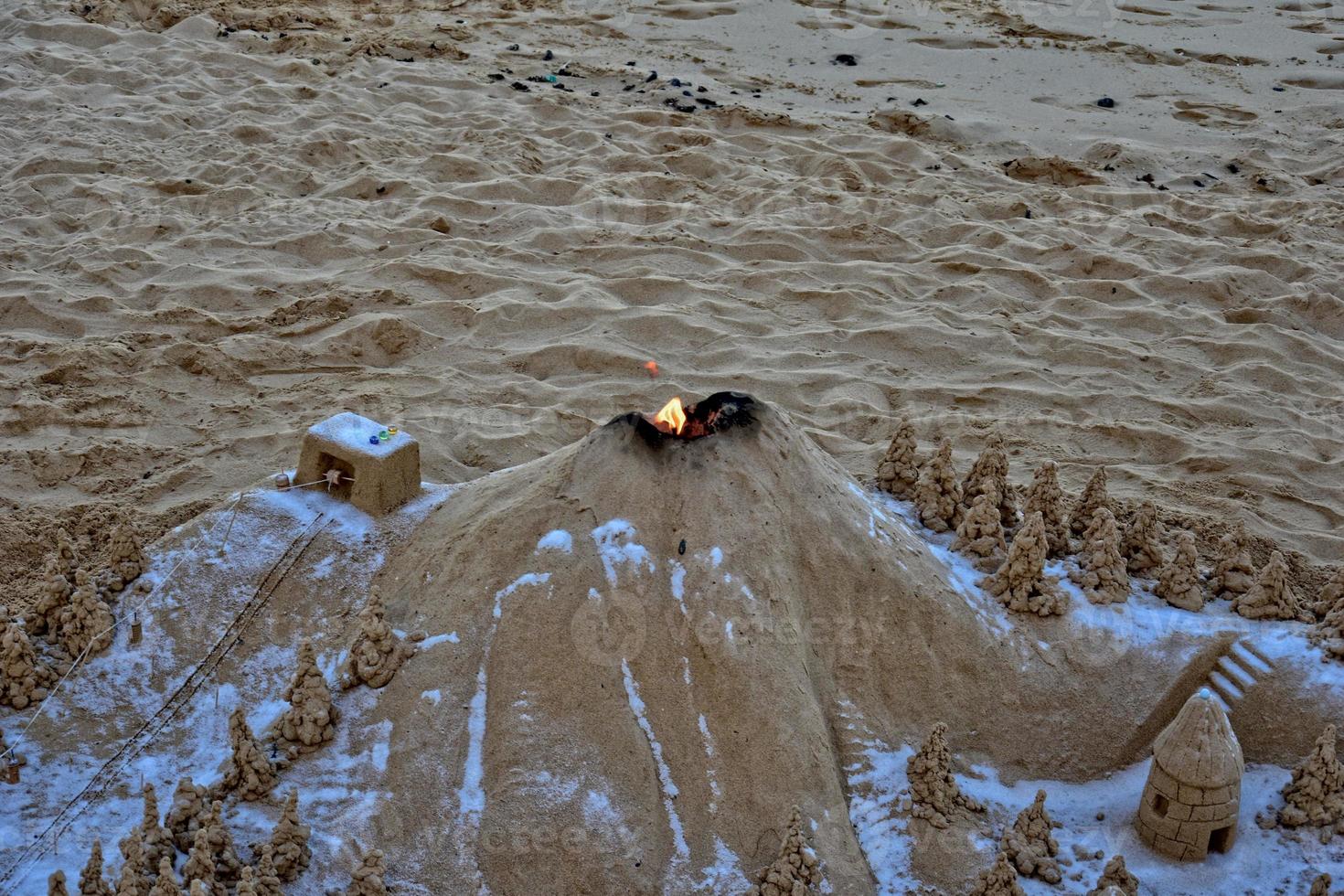 sand sculpture on the beach against the backdrop of the ocean photo