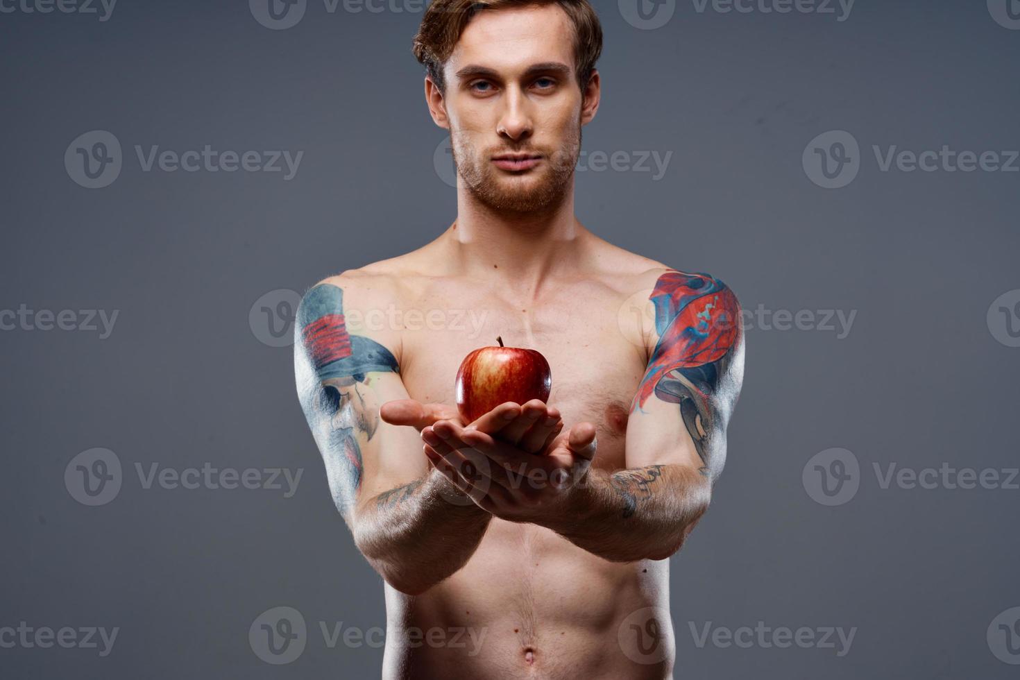 athletic men bodybuilding fitness press pumped up arm muscles tattoo red apple photo