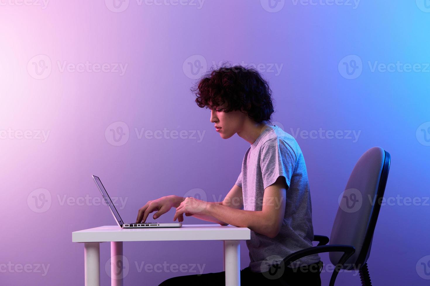 curly guy sitting at the table gaming laptop Lifestyle technology photo