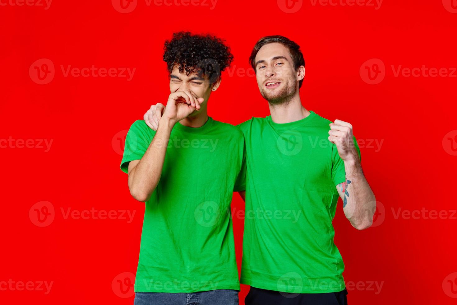 two friends hugging in green T-shirts Friendship team communication photo