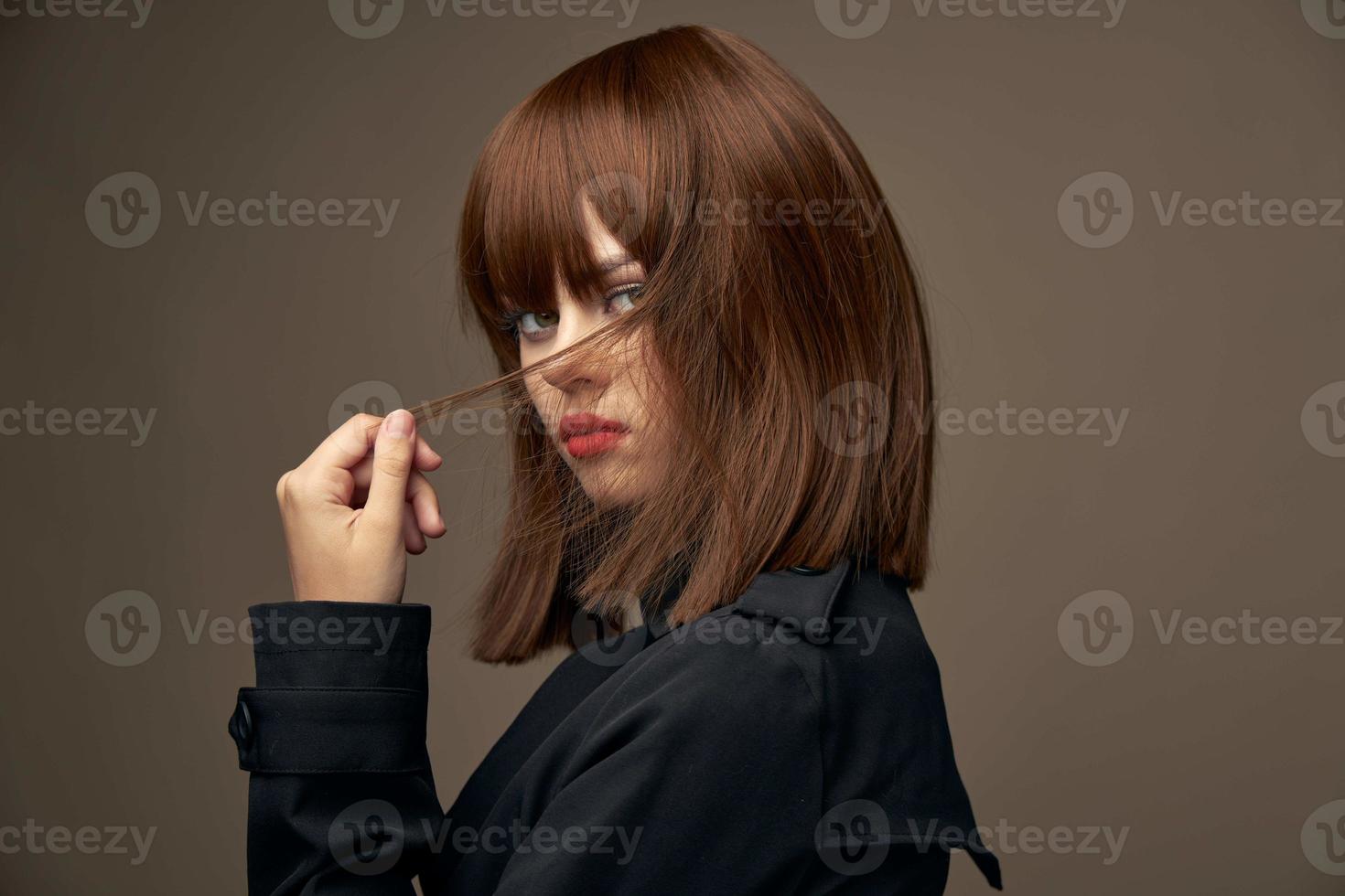 Pretty brunette European appearance black coat cropped view photo