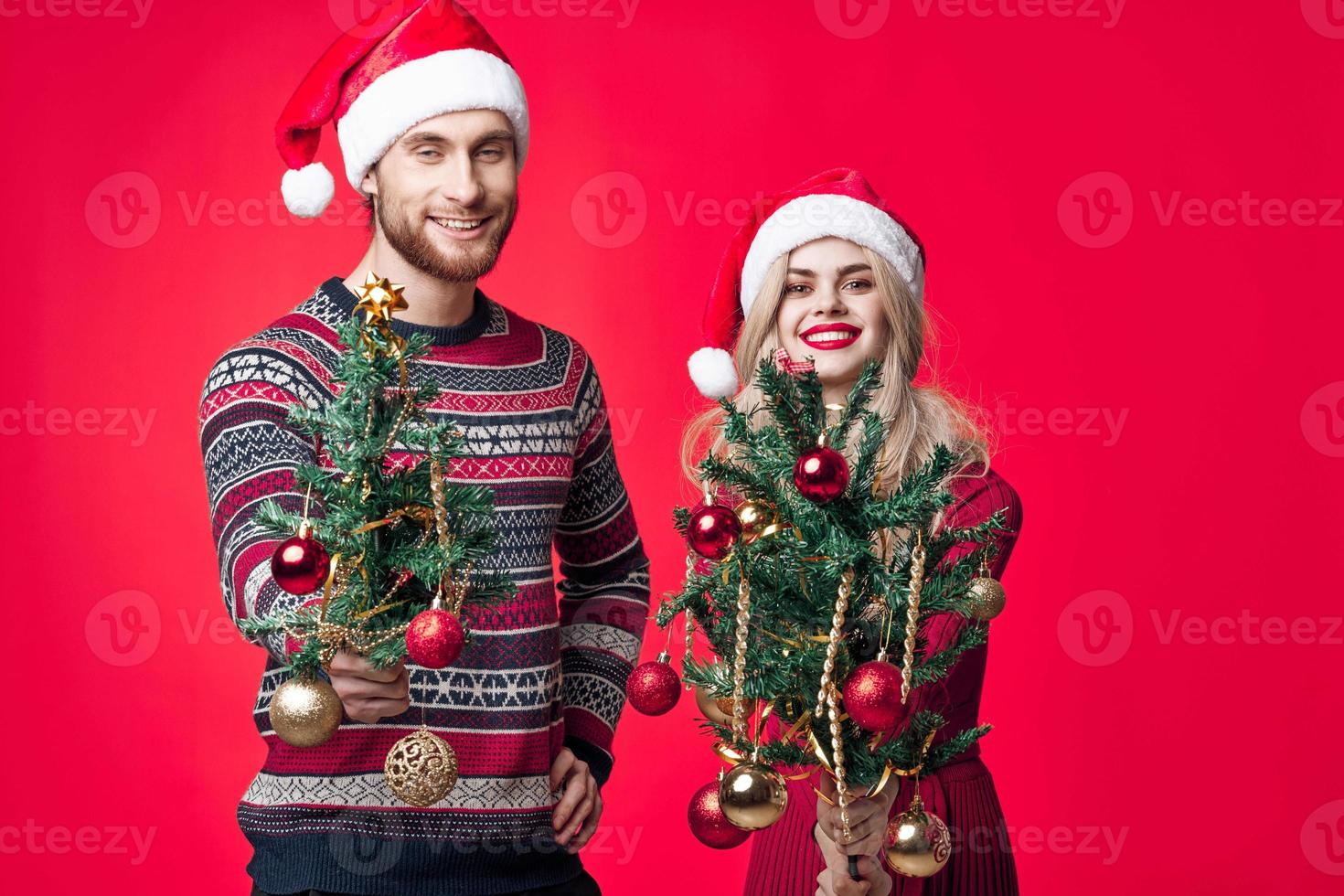 man and woman with christmas trees in hands toys decoration christmas fun photo