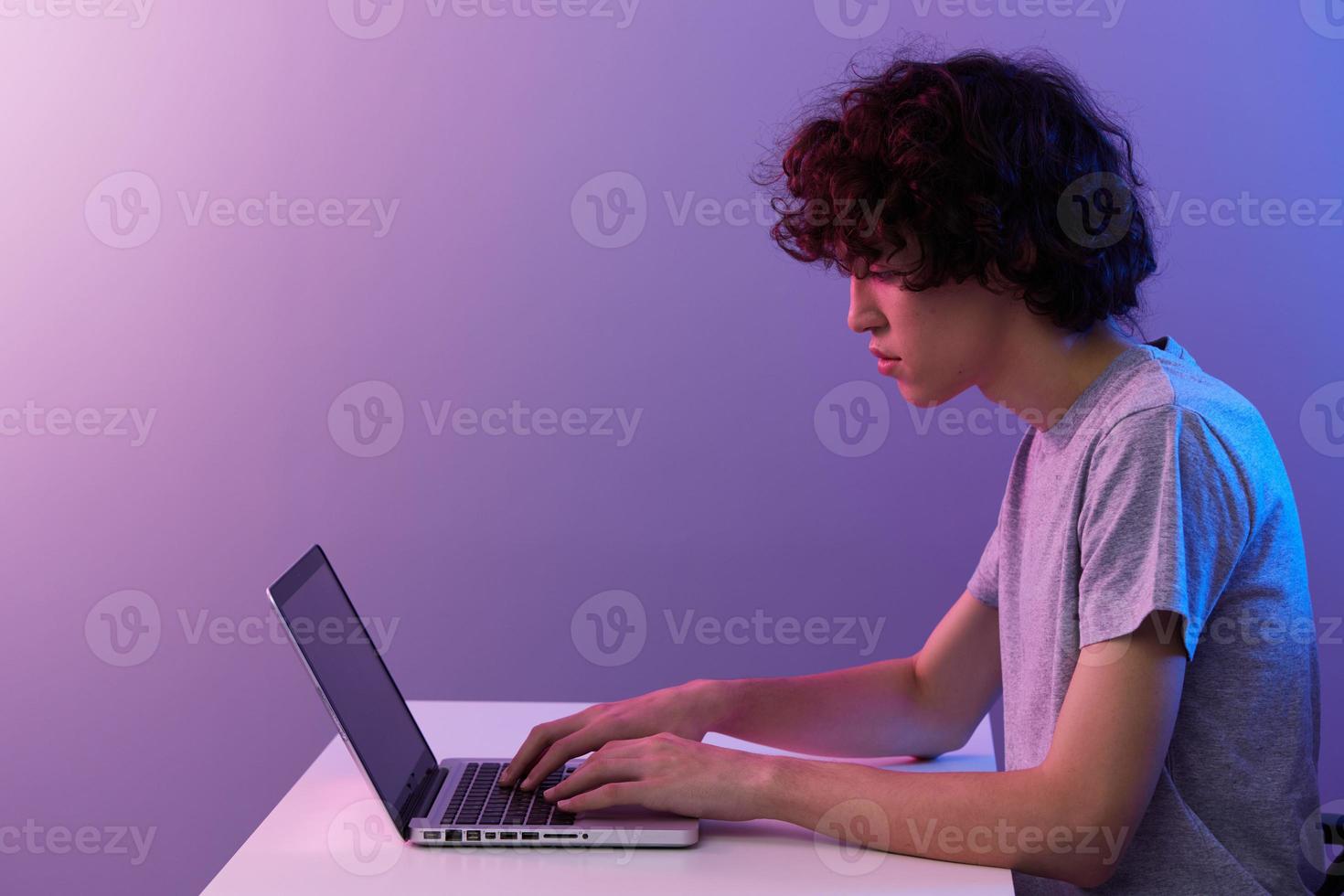 curly guy cyberspace playing with in front of a laptop isolated background photo