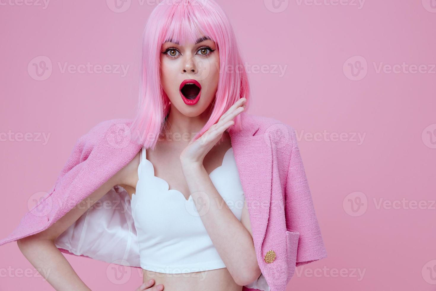 Pretty young female in a pink suit gesturing with his hands emotions fun color background unaltered photo