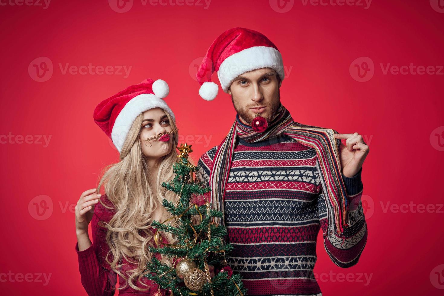 man and woman new year celebration together christmas red background photo
