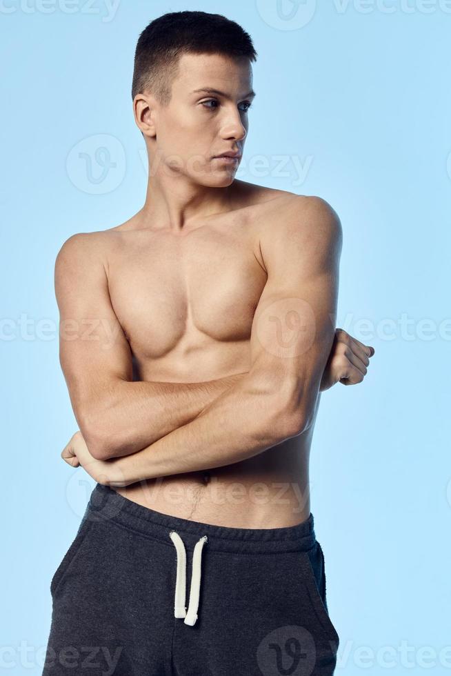 naked man in shorts and crossed his arms over his chest and looking to the side bodybuilder fitness sport photo