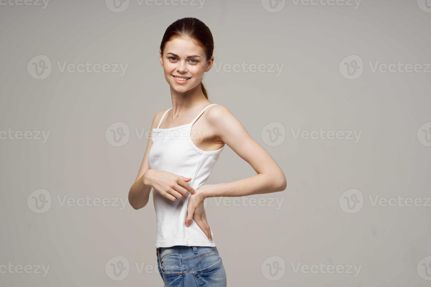cheerful woman in a white t-shirt warm-up joints photo