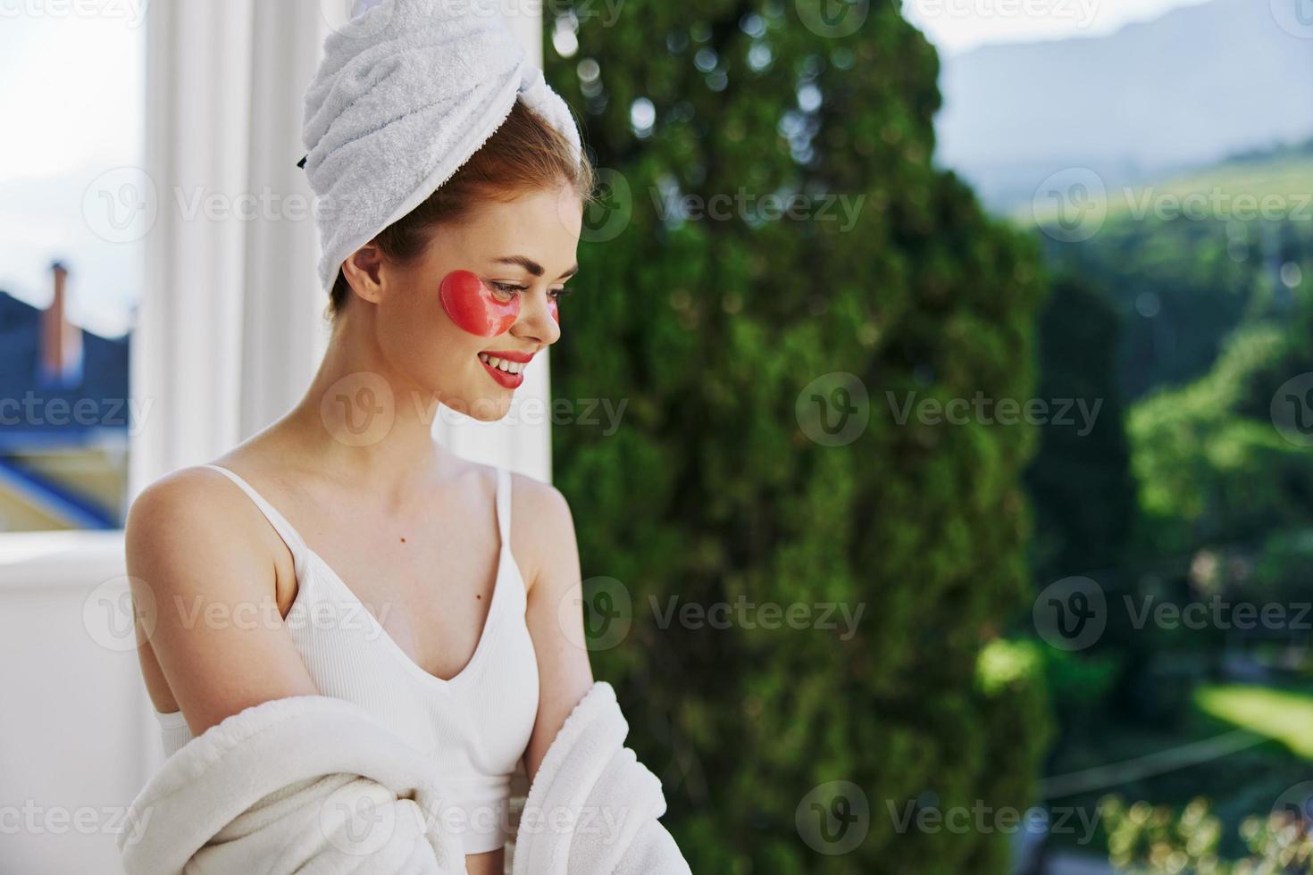 Sensual and beautiful woman with patches on his face admires nature looking on the view photo