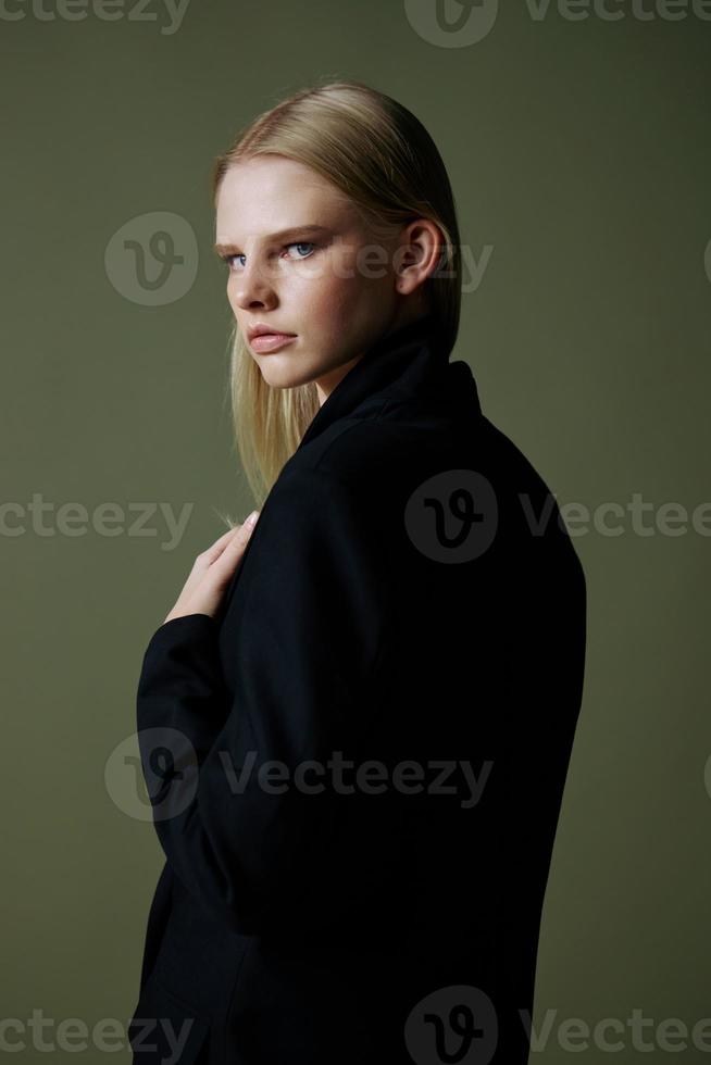 An elegant lady looks to the side posing in isolation on a green background photo