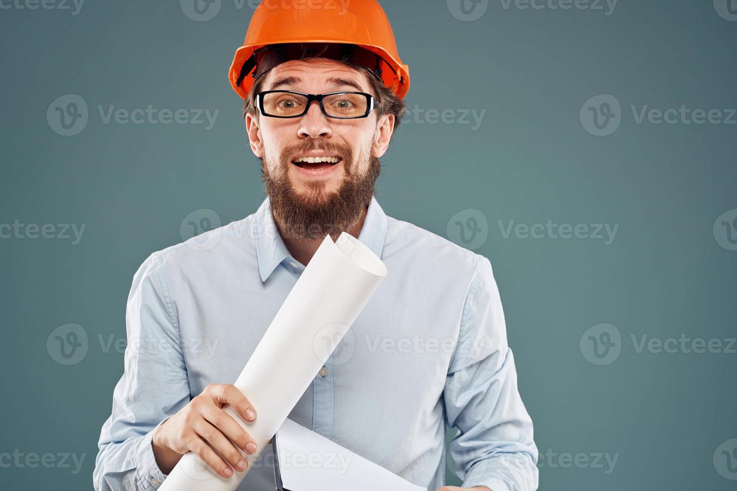 Cropped view of cheerful bearded man in orange paint in glasses with documents in hands photo