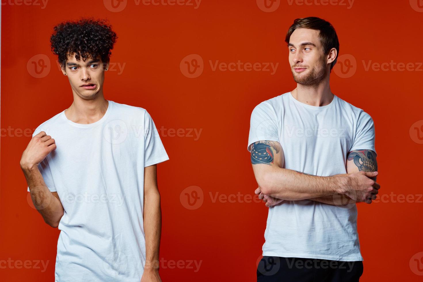 men in white t-shirts communication friendship red background photo