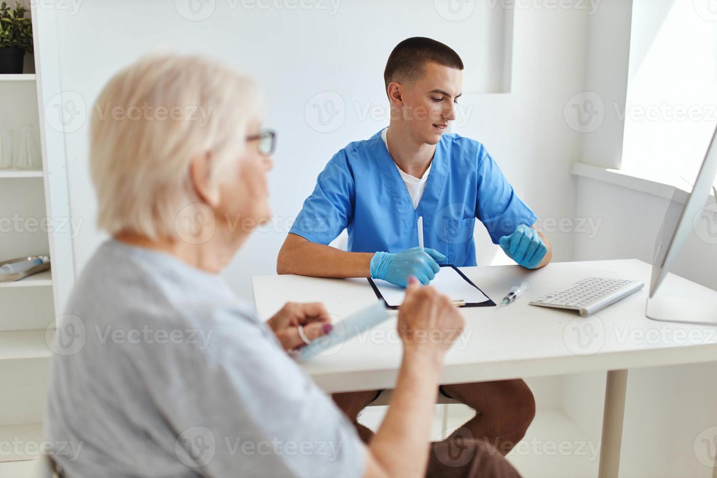 elderly woman patient talking to doctor diagnosis photo