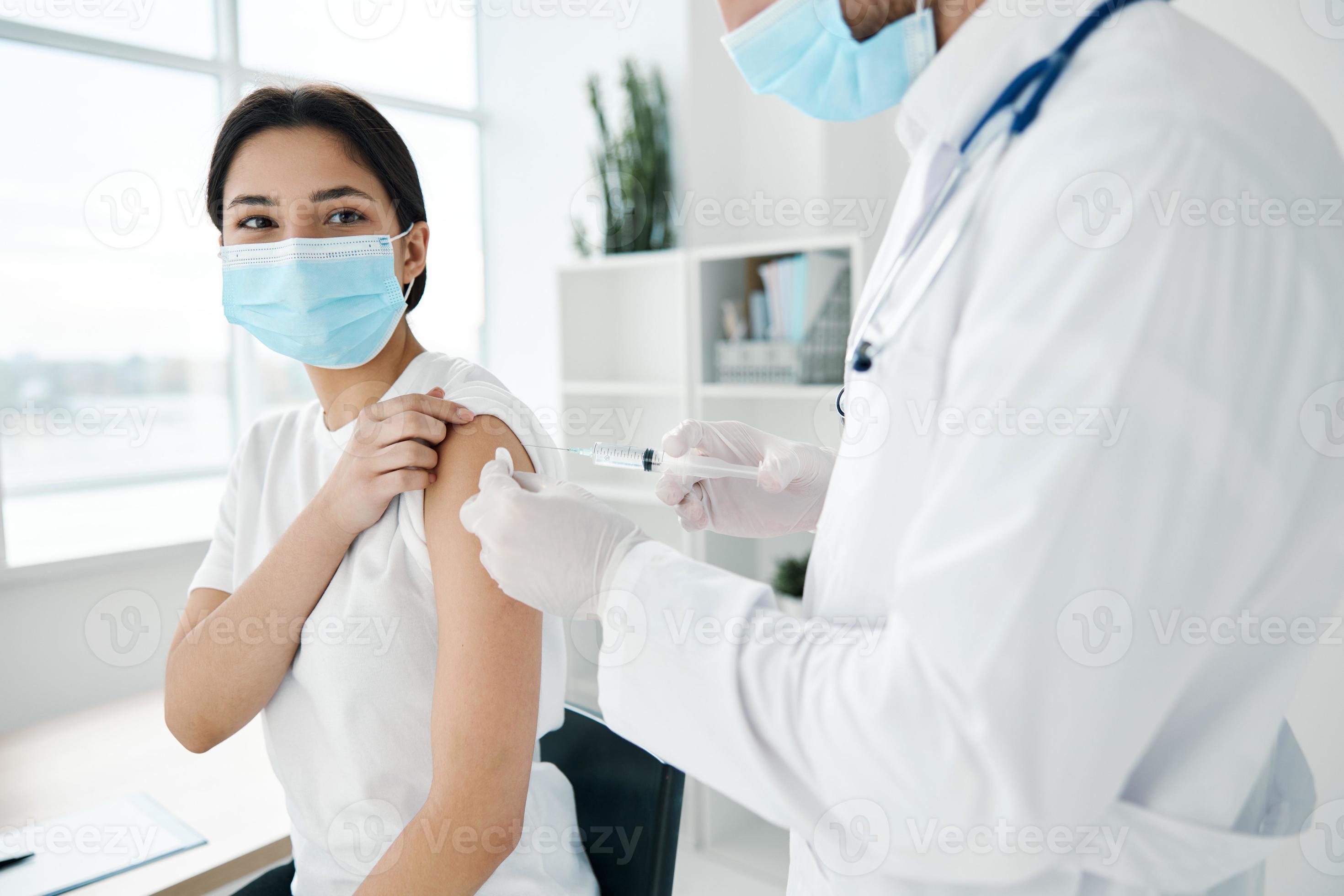 female patient medical masks in hospital and shoulder injection epidemic covid19 vaccine