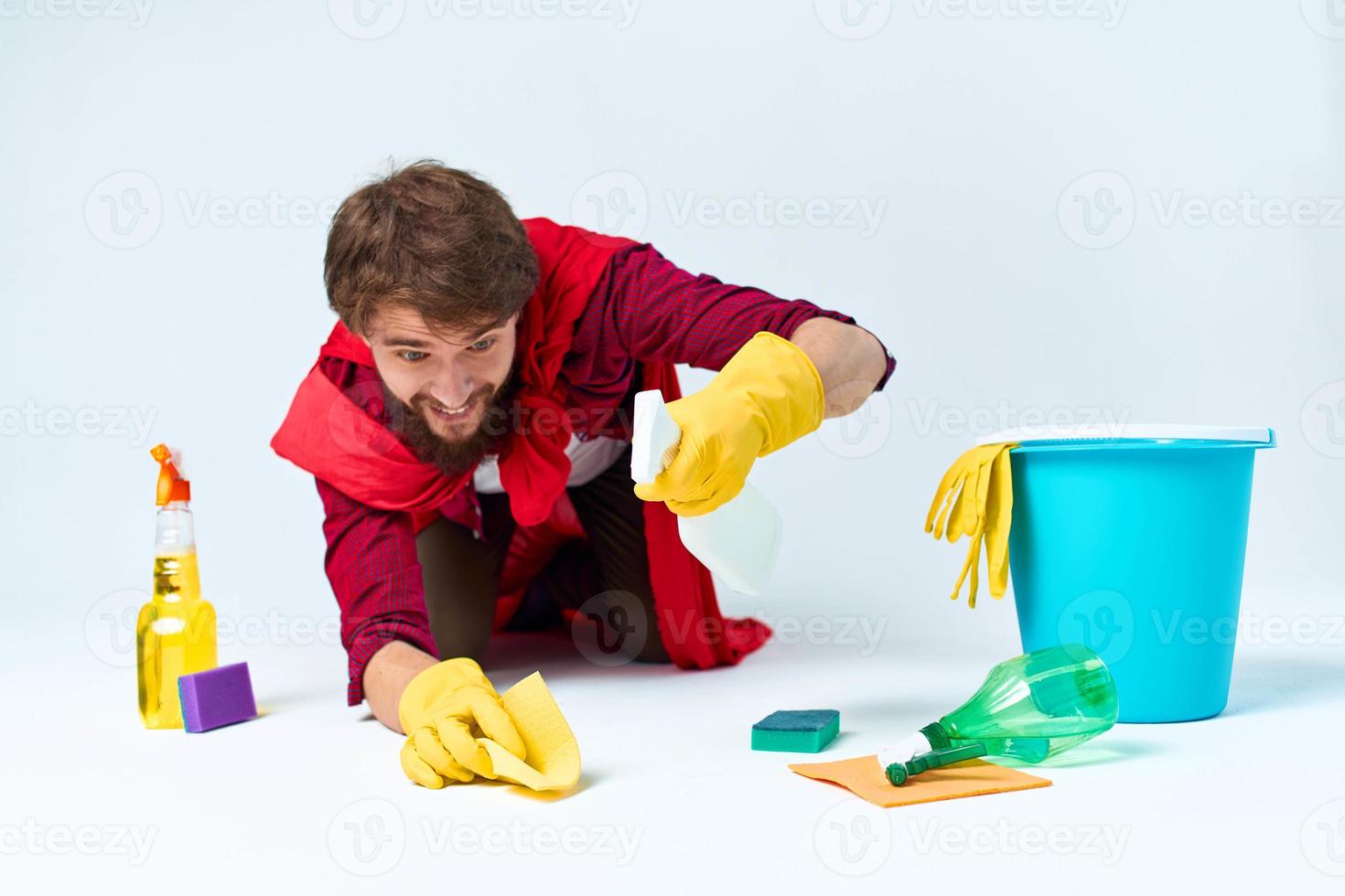 Man on the floor cleaning the house cleaning supplies Professional photo