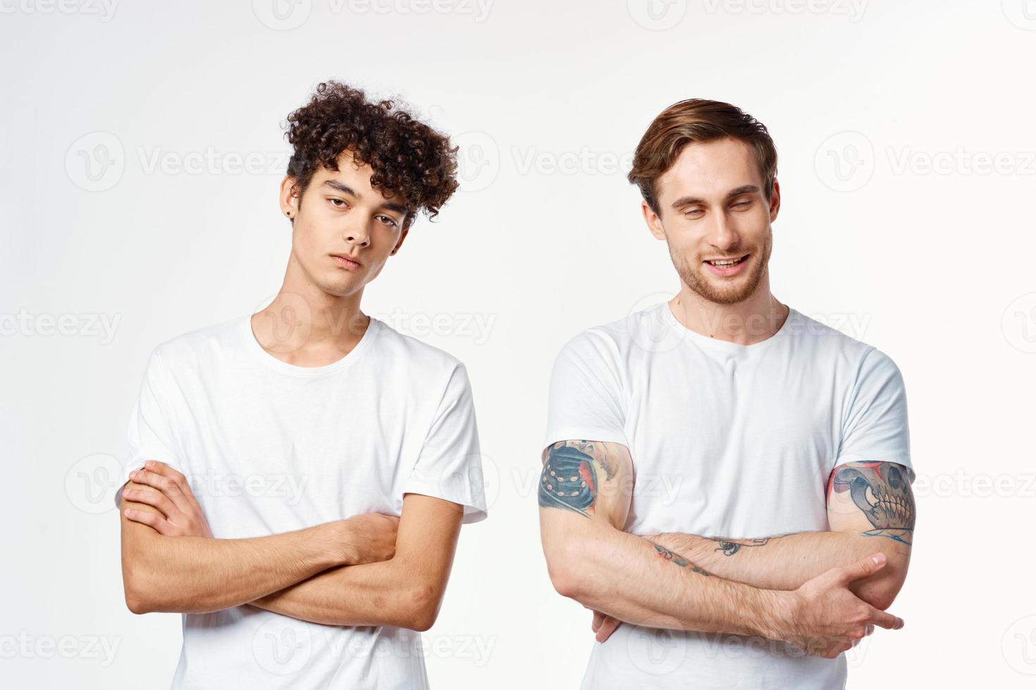 funny two men in white t-shirts are standing side by side isolated background photo
