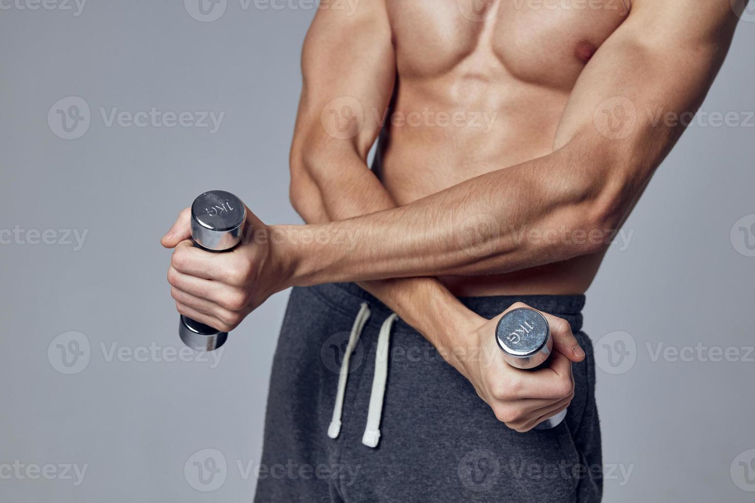 fitness dumbbells in hands workout studio close-up photo