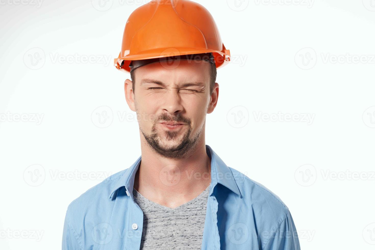 man in orange helmet blueprints builder light background photo