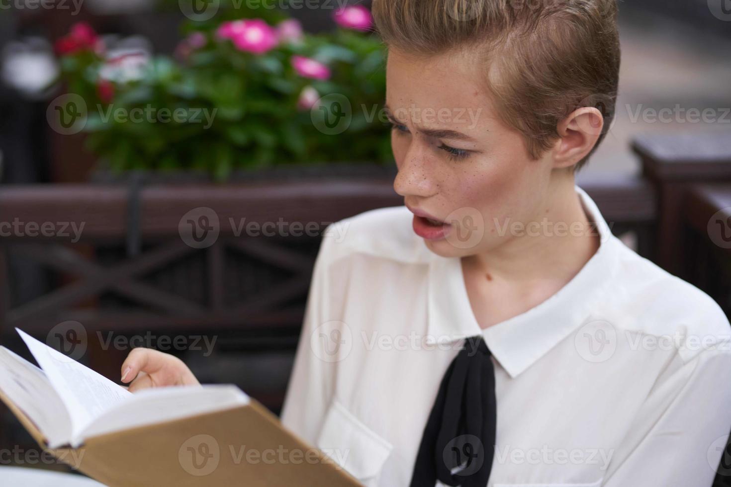 student with a book in his hands reading walk in the fresh air education photo