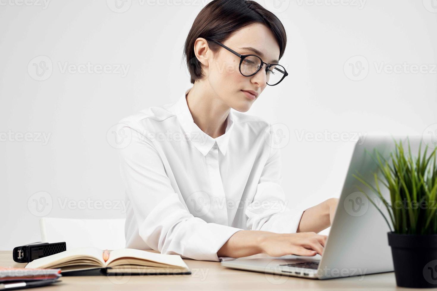 woman in costume in front of laptop documents Professional Job light background photo