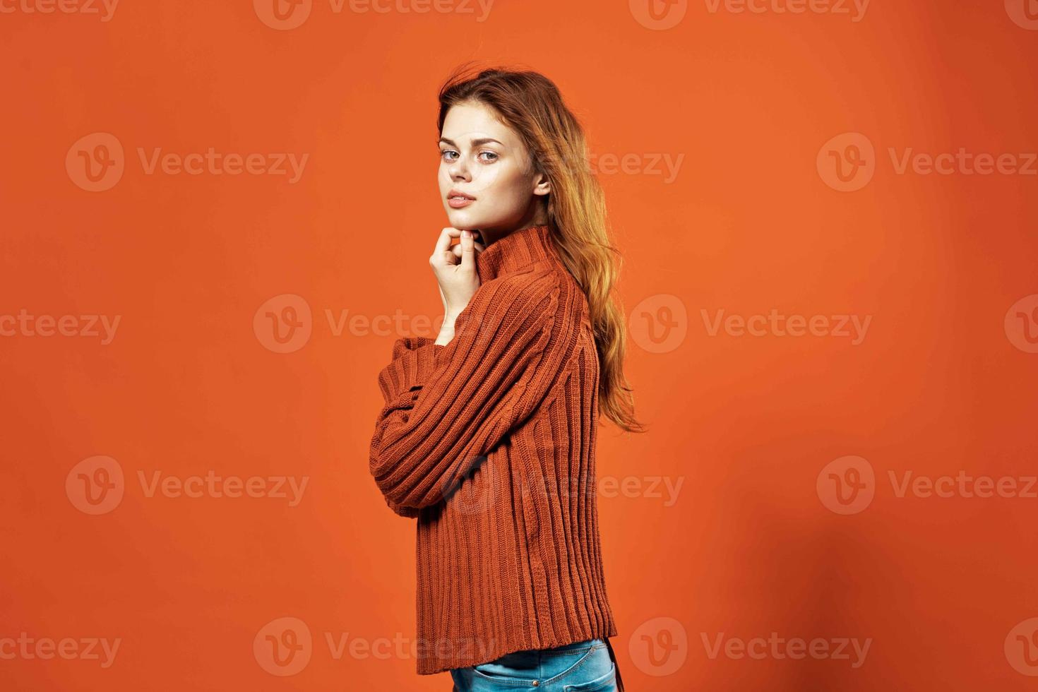 woman in red sweater fashion studio posing red background photo