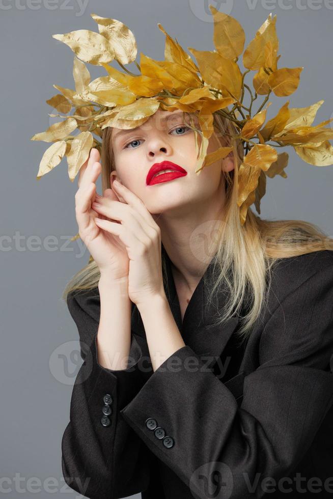 woman golden leaves on the head in black jacket studio model unaltered photo