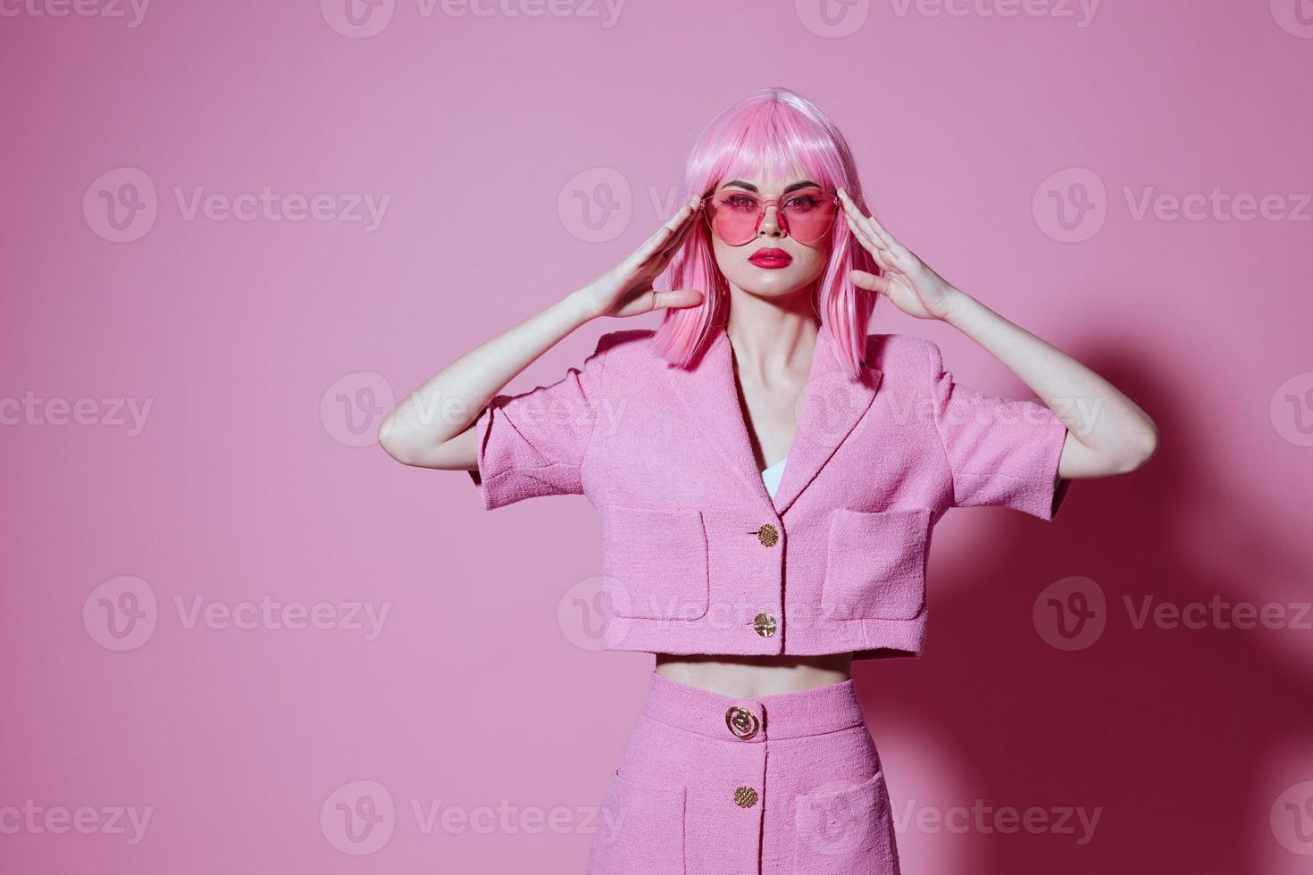 Positive young woman gesturing with hands pink jacket lifestyle glamor monochrome shot unaltered photo