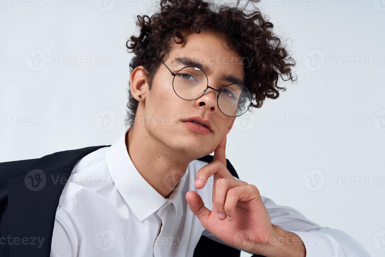 guy in glasses and in a classic suit on a light background portrait close-up photo