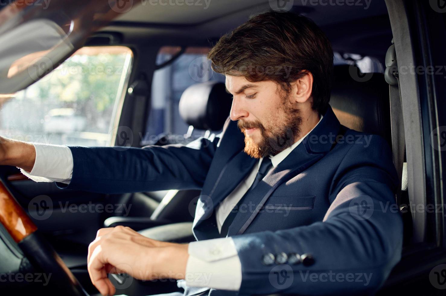 businessmen in a suit in a car a trip to work success photo