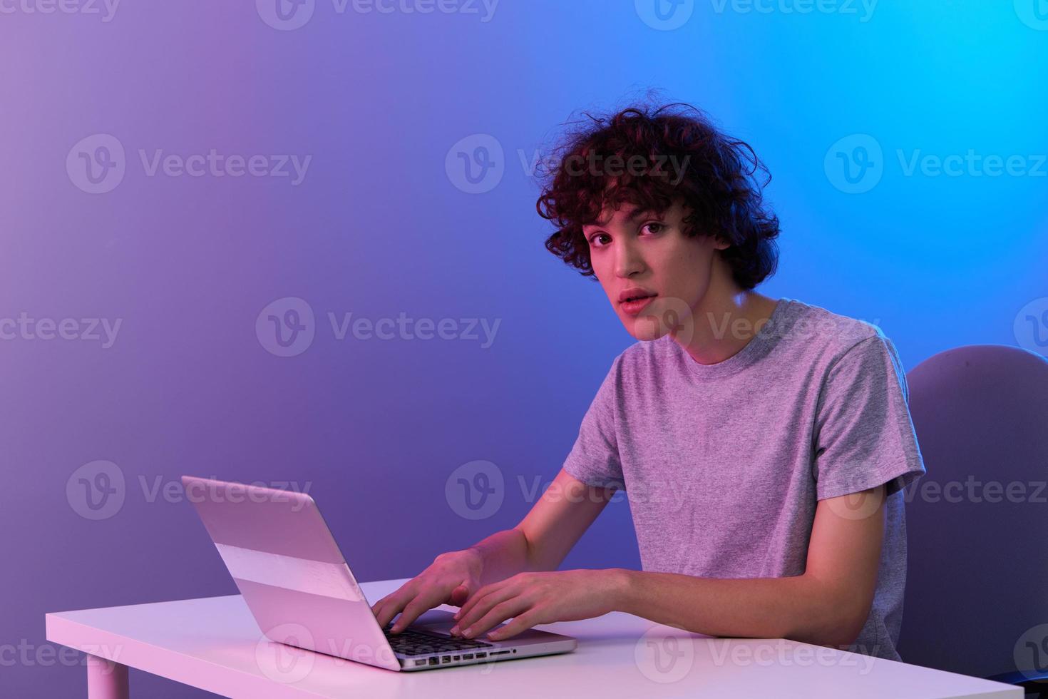 curly guy in front of laptop entertainment Lifestyle technology photo