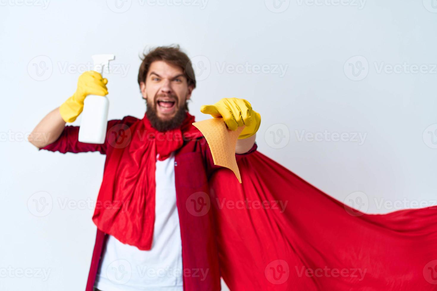 Emotional man in red raincoat detergent house cleaning service light background photo