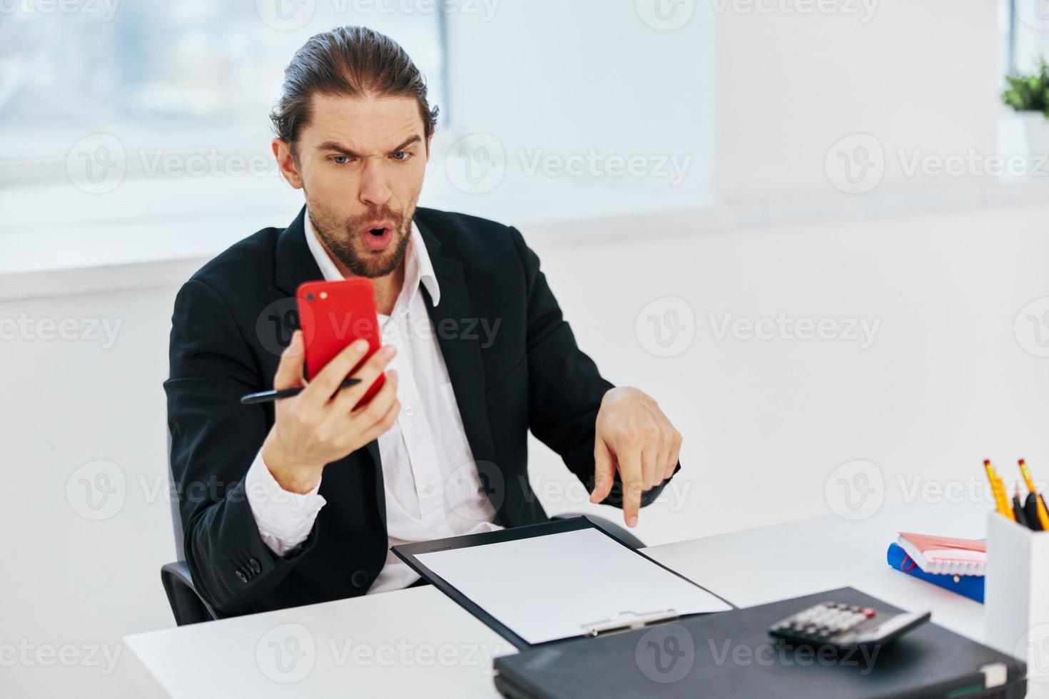 Man at the desk documents communication by phone technology photo