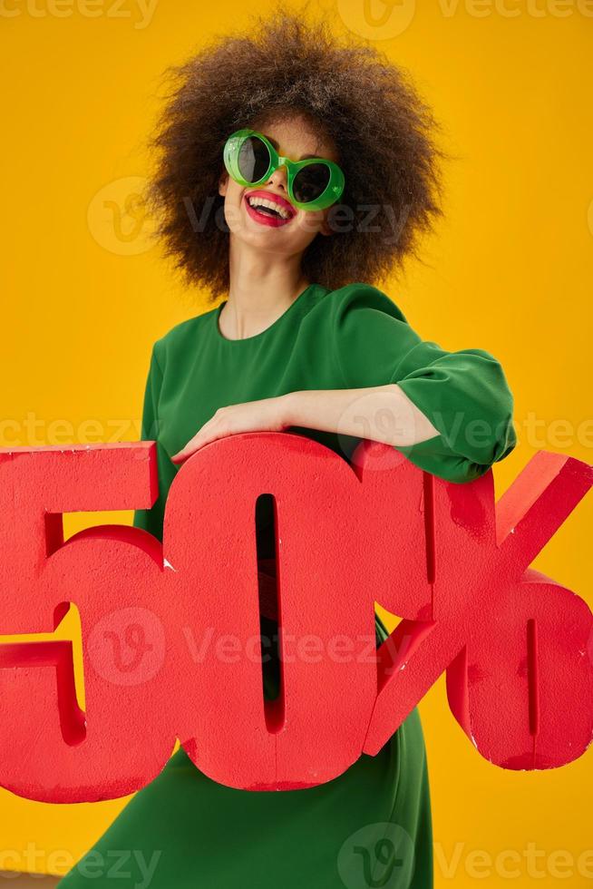 Positive young woman curly hairstyles green dress fifty percent discount studio model unaltered photo