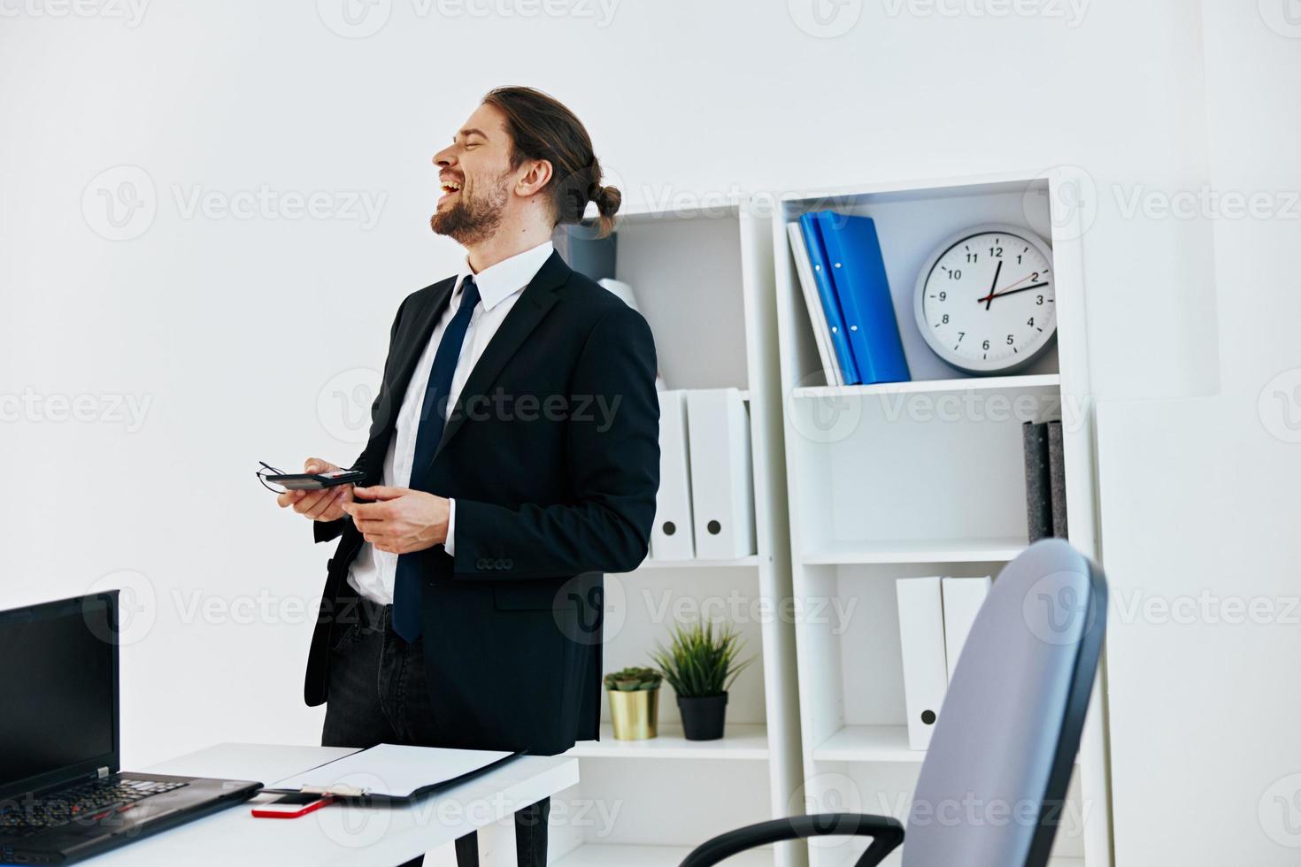 man in a suit in the office with documents technologies photo