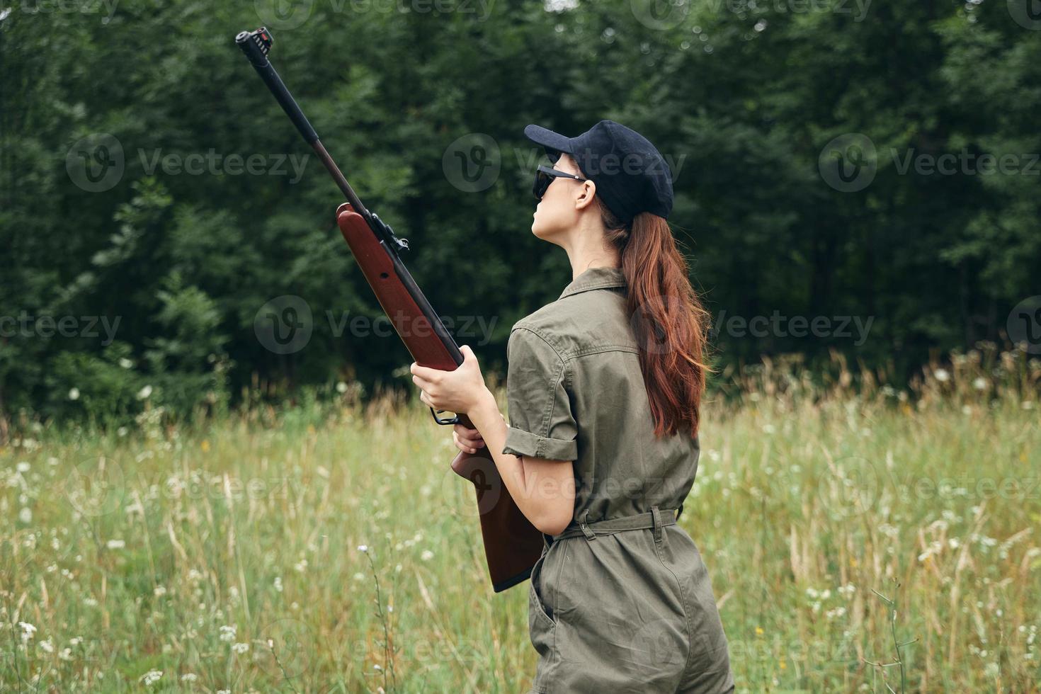 Woman soldier Arms in hand, hunt walk the fresh air fresh air photo