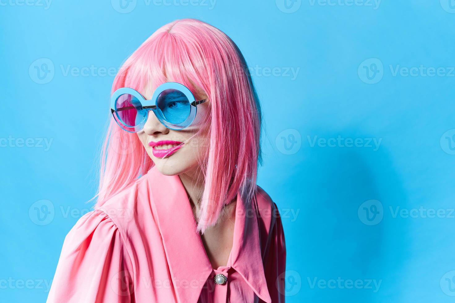 glamorous woman in blue glasses wears a pink wig studio model unaltered photo