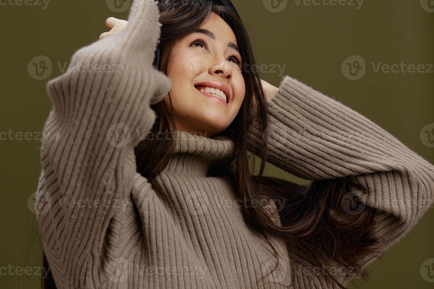 beautiful woman in headphones listening to music emotions Green background photo