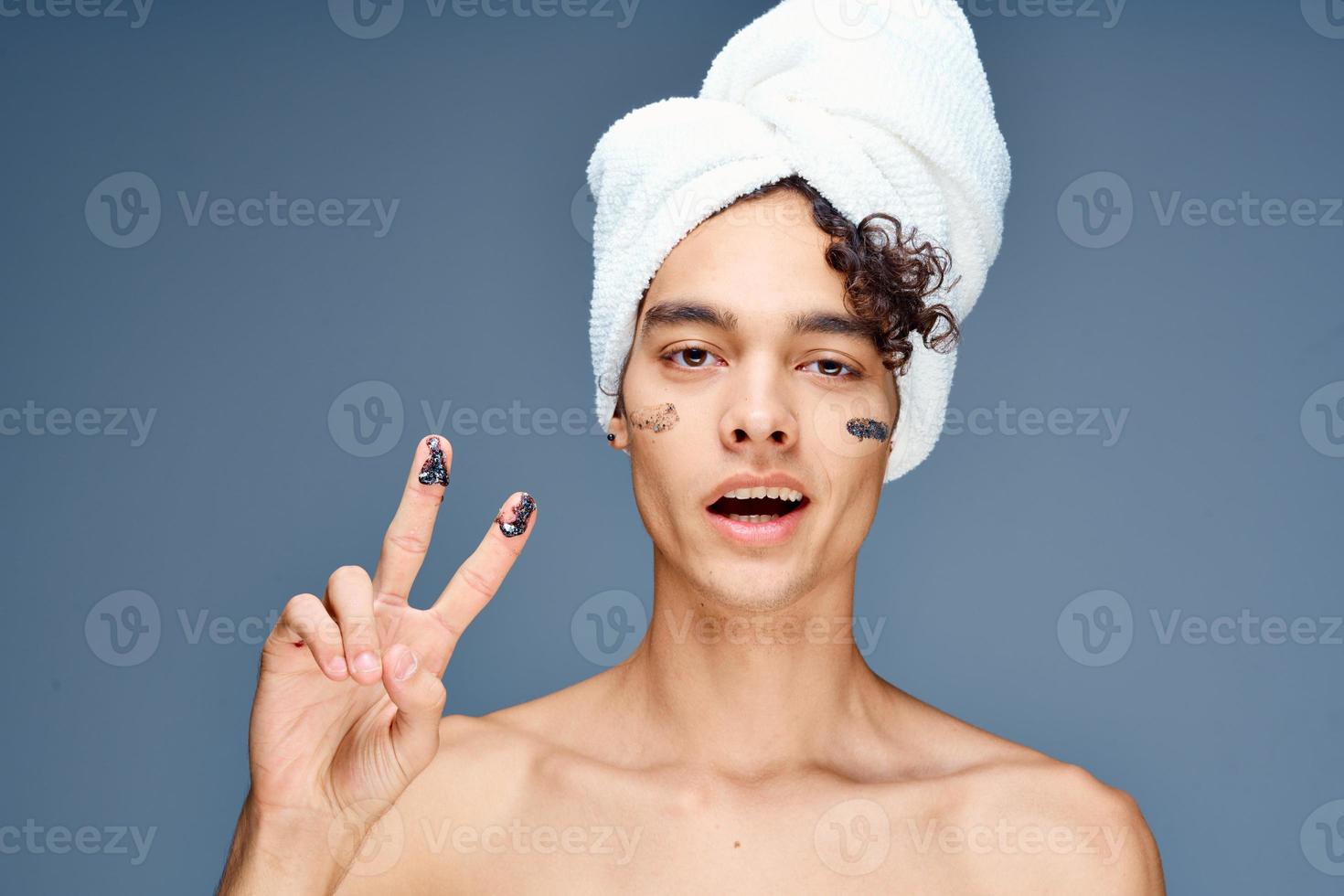 guy with bare shoulders with a towel on his head photo