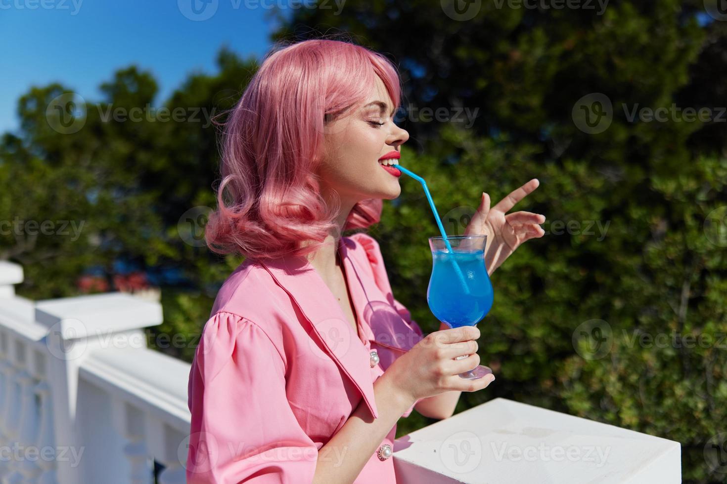 portrait of beautiful woman with pink hair summer cocktail refreshing drink Happy female relaxing photo