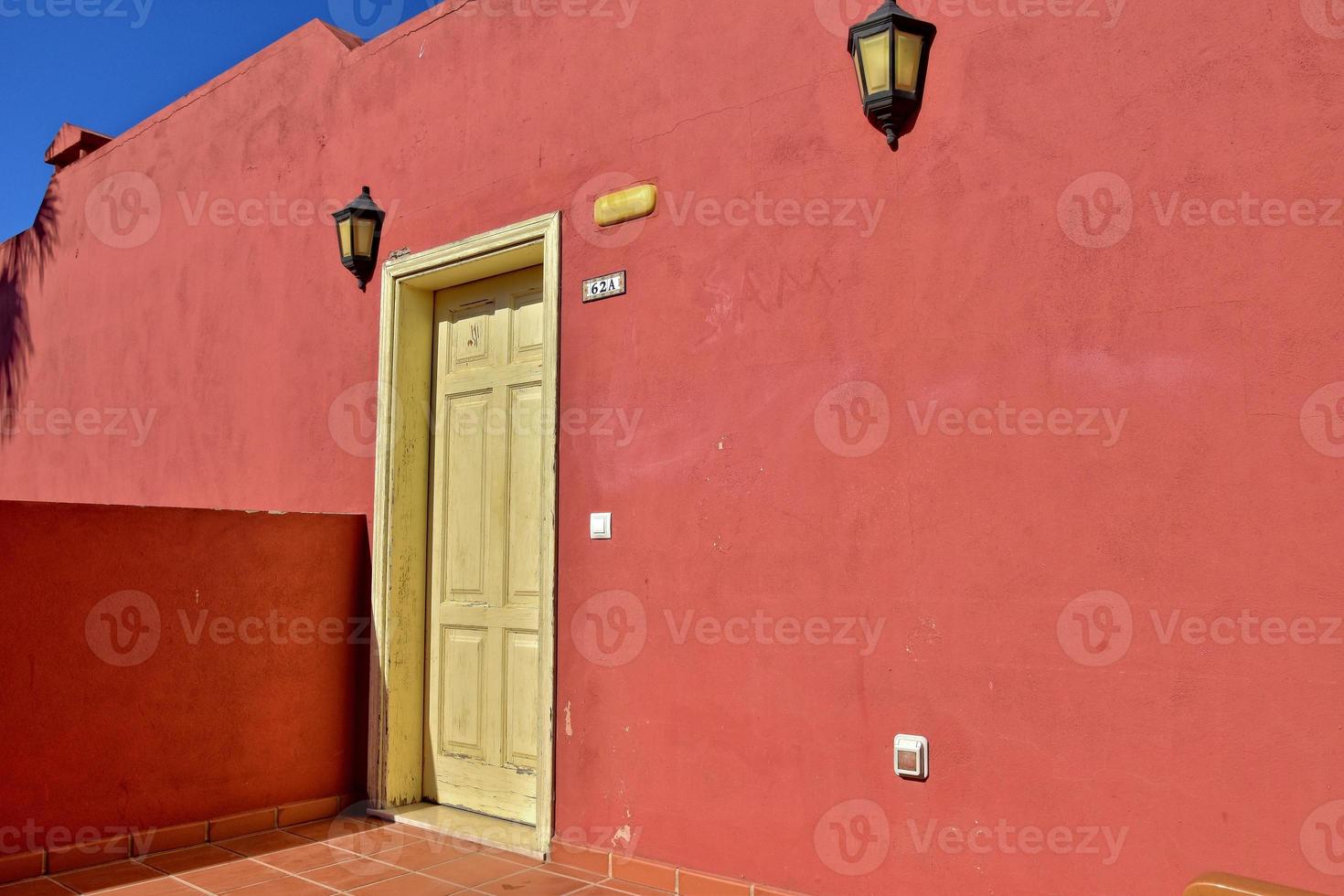 old vintage entrance door on the background of red wall photo