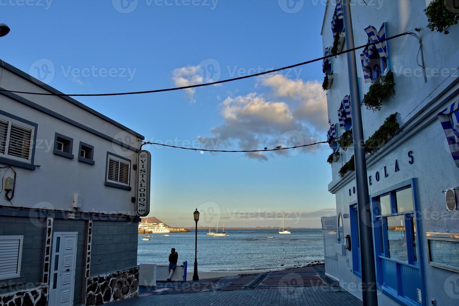 view of the white houses with blue shutters on the background of the oceans on the Spanish island of Furertaventra photo