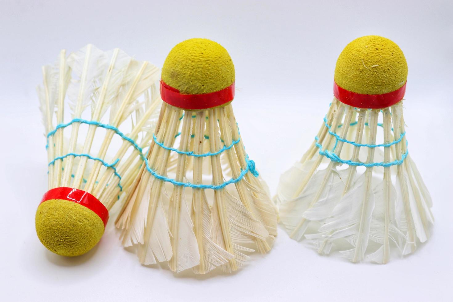 3 White feathers badminton shuttlecocks on white background photo