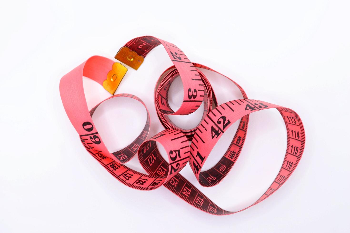 Sewing tape measure cloth ,pink tape double scale measurement for sewing with white background photo