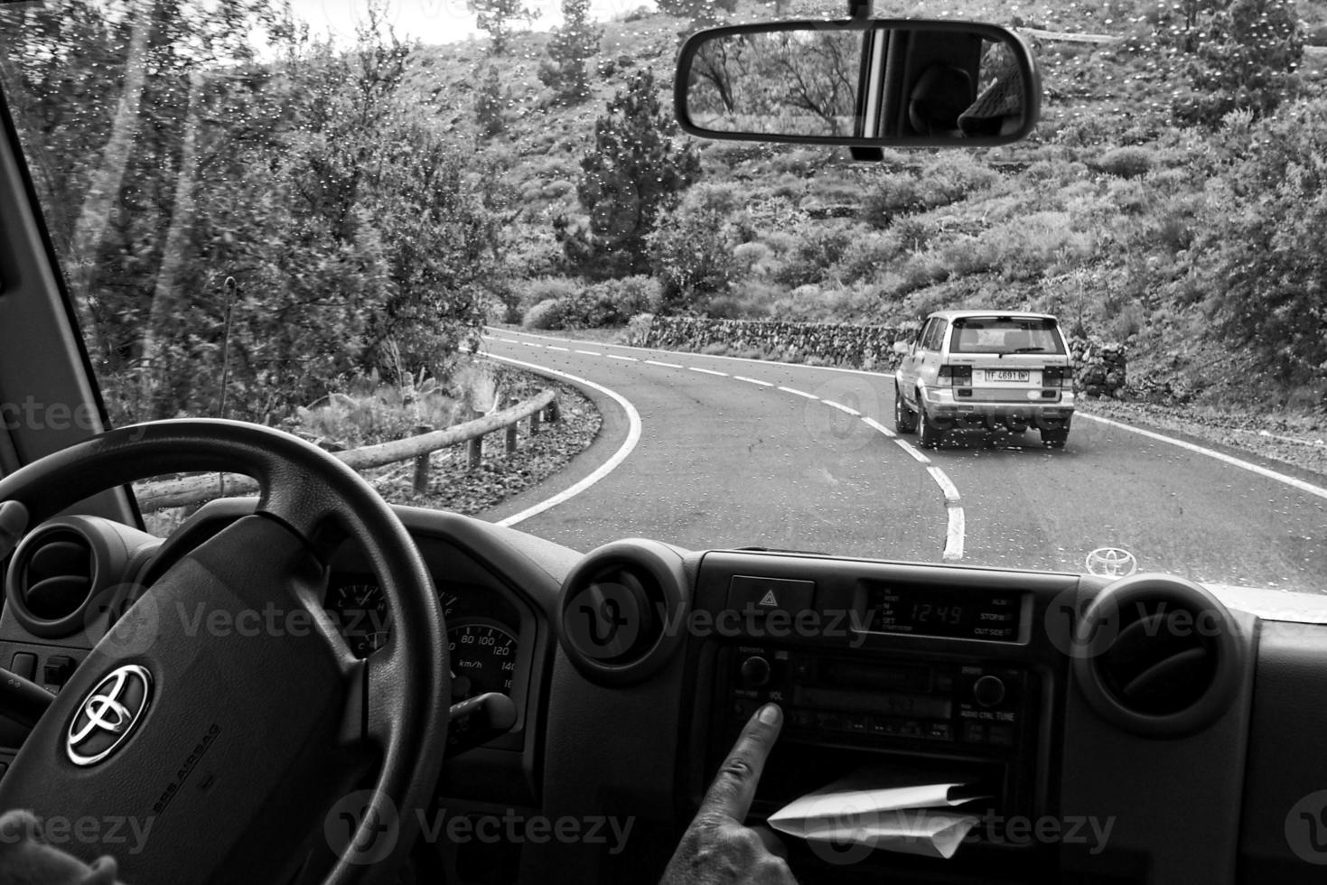 white off-road cars traveling on the roads around the Teide volcano on the Spanish Canary Island of Tenerife for a trip photo